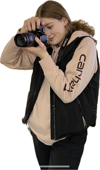 Student holding camera