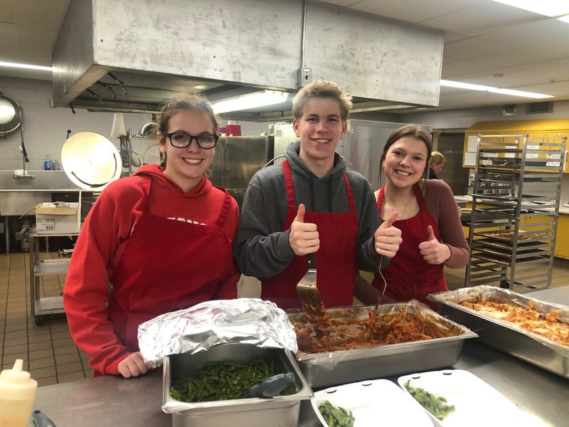 students serving lasagna