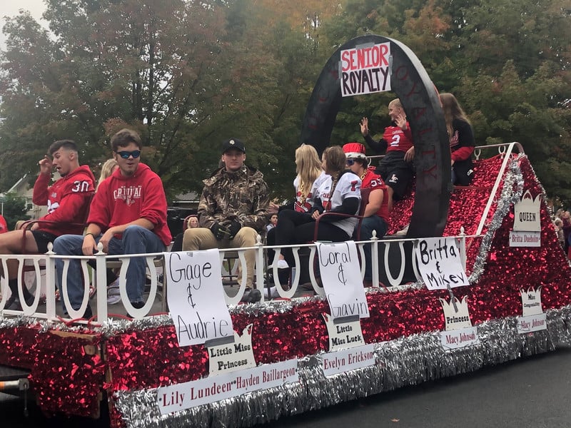 Students riding on a parade float
