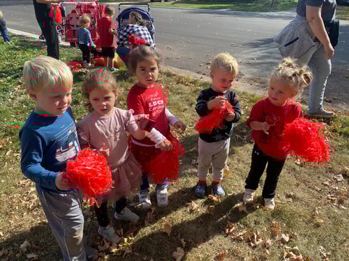 children cheering at a parade