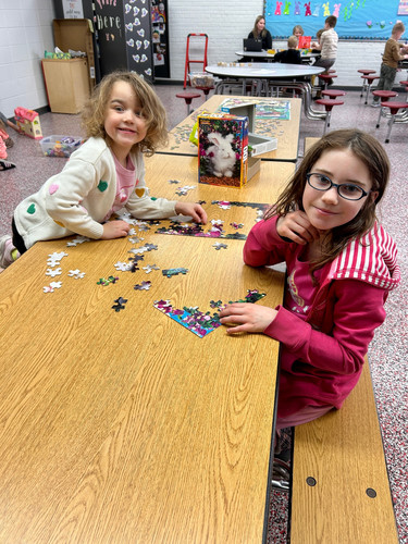 two students putting a puzzle together
