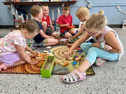 children sitting on the floor playing games