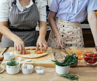 two people cooking